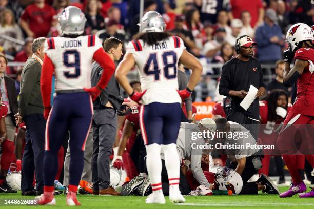 Kyler Murray of the Arizona Cardinals is looked over on the field after being injured against the New England Patriots during the first quarter of...