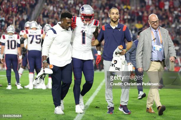 DeVante Parker of the New England Patriots is assisted off the field after a play against the Arizona Cardinals during the first quarter of the game...