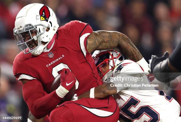 Isaiah Simmons of the Arizona Cardinals is tackled by Marcus Jones of the New England Patriots after intercepting a pass by Mac Jones of the New...