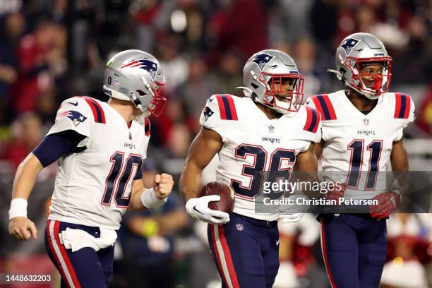 Kevin Harris of the New England Patriots celebrates with Mac Jones and Tyquan Thornton after scoring a 14 yard touchdown against the Arizona...