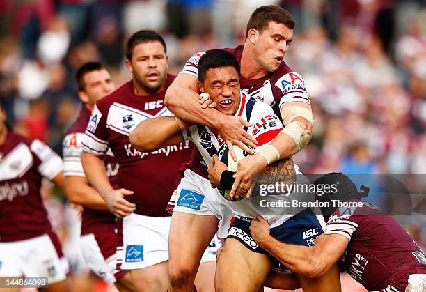 Mose Masoe of the Roosters is tackled by the Roosters defence during the round 11 NRL match between the Manly Warringah Sea Eagles and the Sydney...