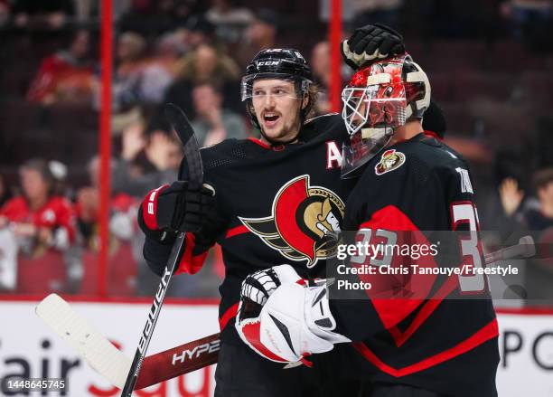 Thomas Chabot and Cam Talbot of the Ottawa Senators celebrate a 3-0 win against the Anaheim Ducks at Canadian Tire Centre on December 12, 2022 in...