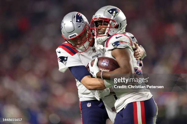 Pierre Strong Jr. #35 of the New England Patriots celebrates with Mac Jones after scoring a touchdown against the Arizona Cardinals during the fourth...