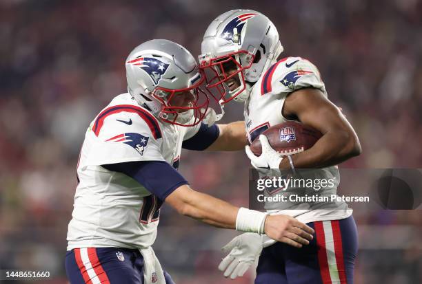 Pierre Strong Jr. #35 of the New England Patriots celebrates with Mac Jones after scoring a touchdown against the Arizona Cardinals during the fourth...