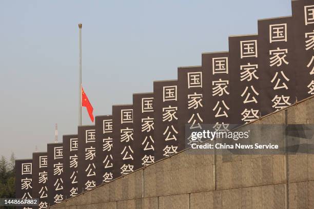 China's national flag flies at half mast during the state memorial ceremony for China's National Memorial Day for Nanjing Massacre Victims at the...