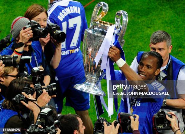 Chelsea's Ivorian forward Didier Drogba celebrates with the trophy after the UEFA Champions League final football match between FC Bayern Muenchen...