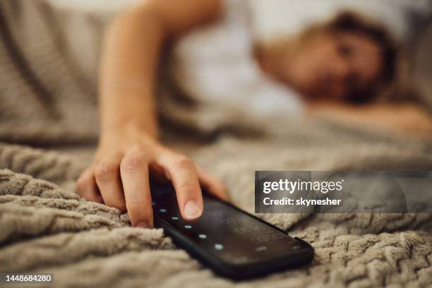 turning off alarm clock! - turning on or off stock pictures, royalty-free photos & images