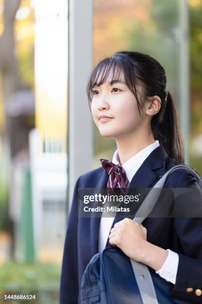 high school student at the bus stop - japan 12 years girl stock pictures, royalty-free photos & images