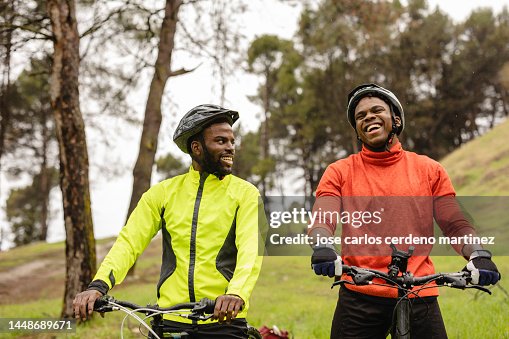 Walking And Cycling Two Friends Laugh And Enjoy A Day With