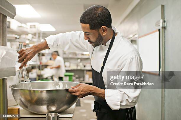 chef combines foods in commerial kitchen - stirring stock pictures, royalty-free photos & images