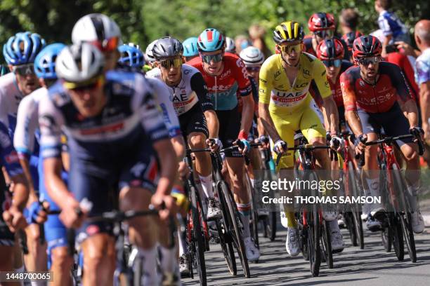 Team Emirates' British rider Adam Yates wearing the overall leader's yellow jersey cycles with the pack of riders in Hendaye during the 3rd stage of...