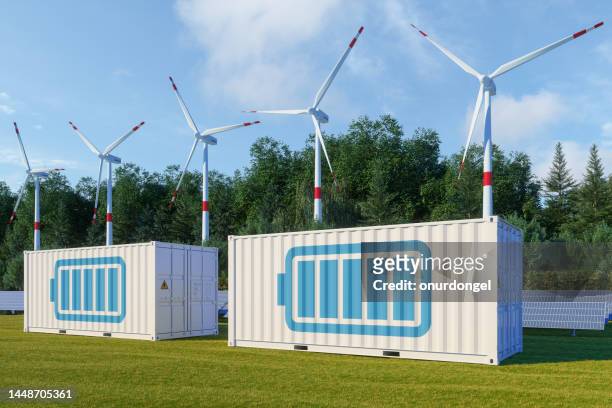 energy storage system with solar panel, wind turbines and li-ion battery container - opslagruimte stockfoto's en -beelden