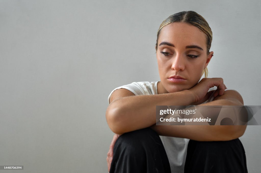 Woman sitting down and feeling depressed