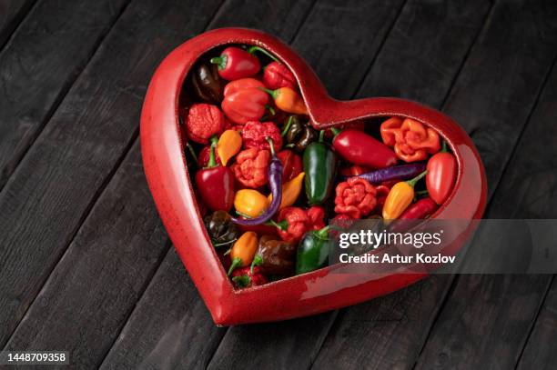 heart with peppers. love for hot peppers. valentine's day gift. lover's, warm, fire, burning, passionate heart. mexican cuisine. indian cuisine. dark background. close-up. copy space - indian spices bildbanksfoton och bilder