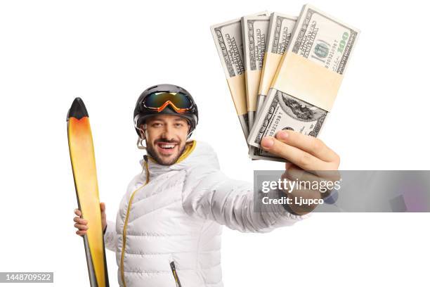 Male skier holding money in front of camera