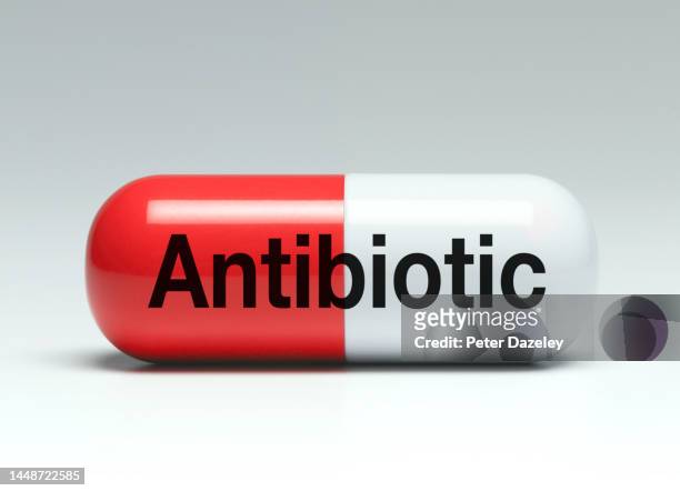 antibiotic tablet on white background - antibiotic resistance stock pictures, royalty-free photos & images