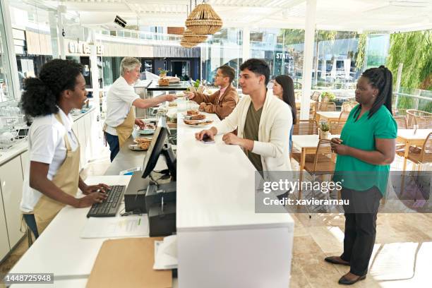 cafe customers communicating with food servers - restaurant queue stock pictures, royalty-free photos & images