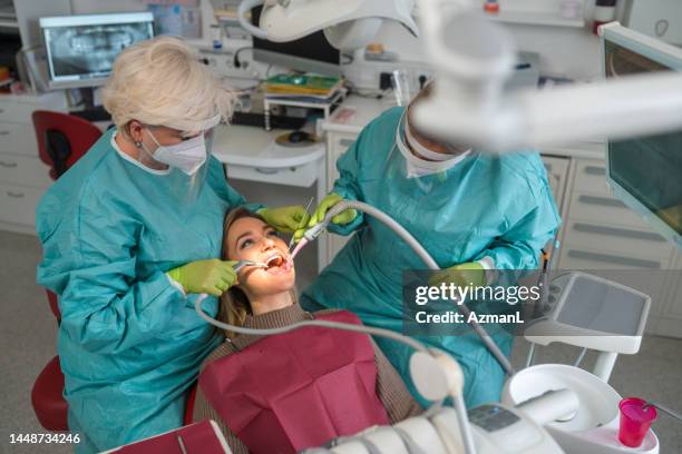 young caucasian woman having a dental check-up exam during pandemic - face shield 個照片及圖片檔