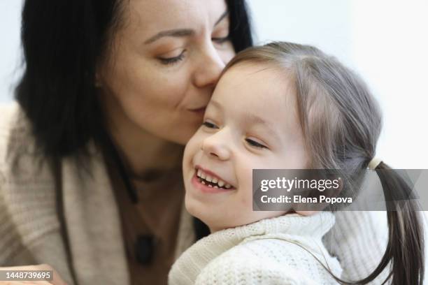 beautiful 5 years old girl having fun with her mother, embracing and kissing - 4 5 years stock pictures, royalty-free photos & images