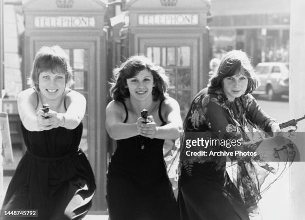 British Pentathletes Wendy Skipworth aged 15, Kathy Tayler aged 17 and Sarah Parker aged 19 posing with sports pistols prior to the World Modern...