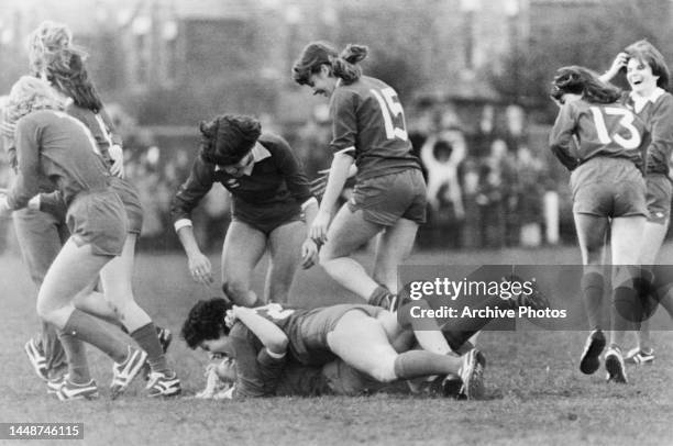 Wives and girlfriends of Liverpool and Everton football players take part in a charity match, Sue Neal celebrating with a prostrate Sue Toshack after...