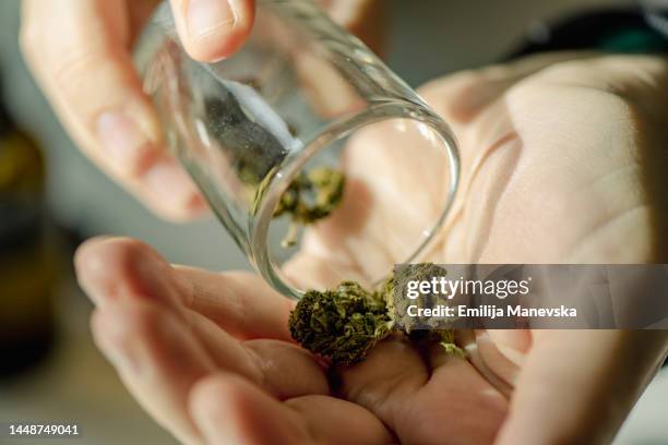 close up of senior woman using cannabis at home - spinello foto e immagini stock