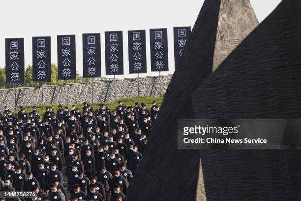 People attend the state memorial ceremony for China's National Memorial Day for Nanjing Massacre Victims at the Memorial Hall of the Victims of the...