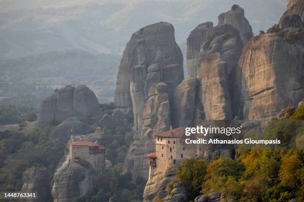 The Rousanou Monastery and The Monastery of Agios Nikolaos Anapafsas at Meteora valley during the sunset on October 28, 2022 in Meteora, Greece.