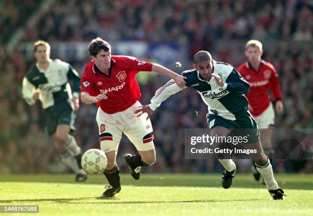 Manchester United player Roy Keane is challenged by Liverpool defender Phil Babb during a Premier League match at Old Trafford on October 1st, 1995...