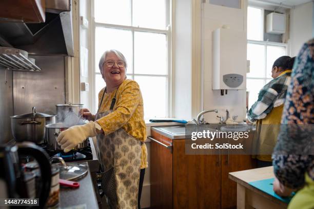 she loves volunteering! - preparing food talking stock pictures, royalty-free photos & images