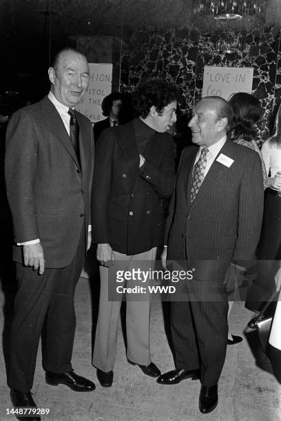Gordon Franklin, S.I. Newhouse, Jr., and Abe Schrader confer at a Fashion Capital of the World, Inc. Runway show in New York.