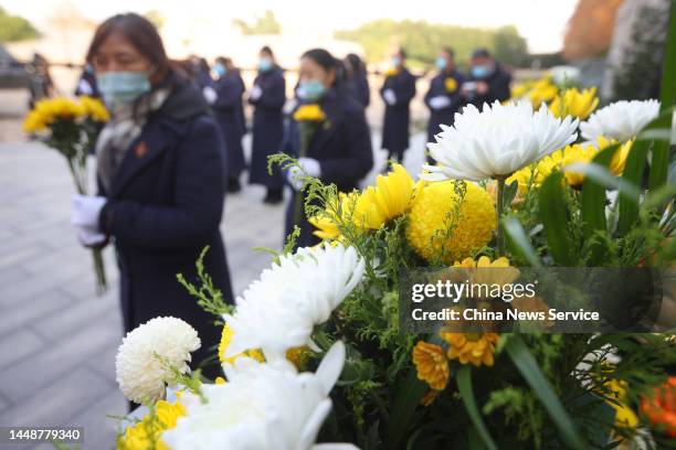 People attend a memorial ceremony for China's National Memorial Day for Nanjing Massacre Victims at the Memorial Hall of the Victims of the Nanjing...