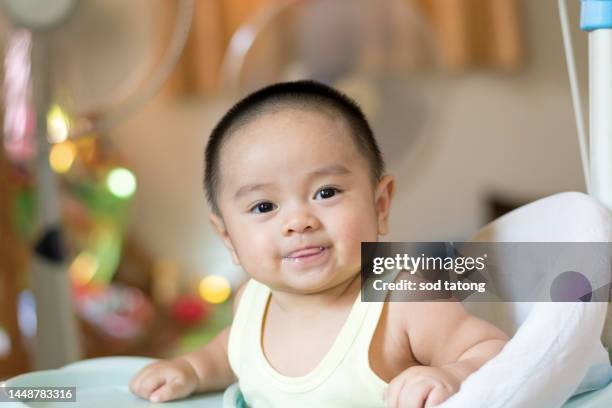 cute small boy lying at bed. childhood concept. light background. smiling child. happy emotion. copyspace. stay home. mockup. horizontal banner. white clothes - asian baby stock pictures, royalty-free photos & images