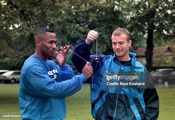 England strikers Les Ferdinand and Alan Shearer wearing Green Flag sponsored kit play a game of conkers during a set up picture at England training...