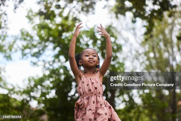 adorable little girl dancing in a park outside in summer - braiding hairstyles for little black girls stock pictures, royalty-free photos & images