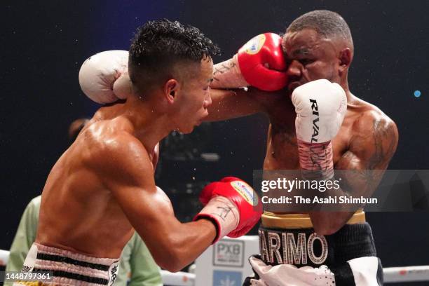 Yoshiki Takei of Japan connects his left on Bruno Tarimo of Australia in the 11th round during their OPBF Super Bantamweight Title Bout at Ariake...