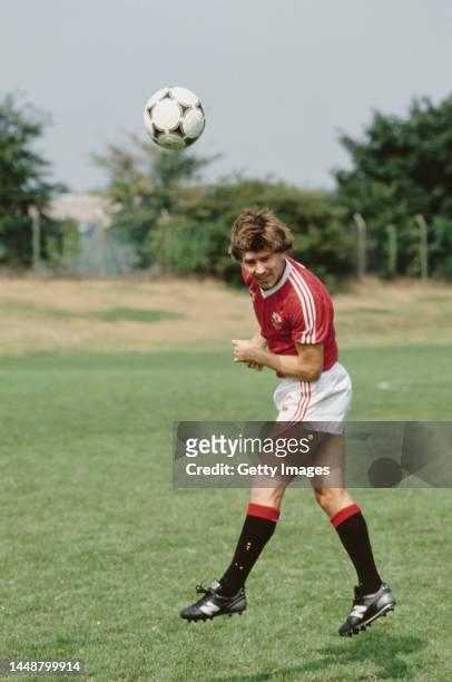Manchester United player Bryan Robson pictured in heading action in the 1983 FA Cup Final Umbro home kit during a photo session in 1983 in United...