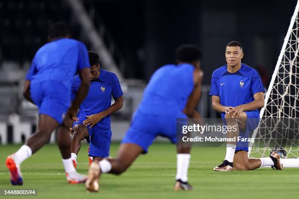 Kylian Mbappe of France stretches during the France Training Session at Al Sadd SC on December 13, 2022 in Doha, Qatar.