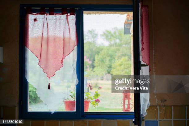 horizontal front view of empty rural kitchen with open window in background. interior design house with nobody. - french provincial interior stock-fotos und bilder