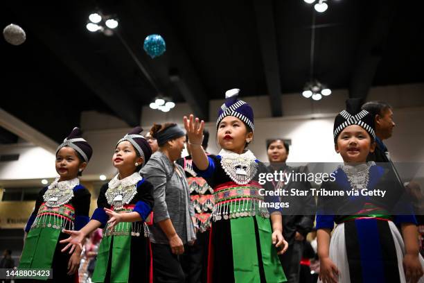 From left, twin sisters Hazel and Hannah Xiong and their cousins Madison Lee and Sophia Moua play the classic Hmong game, Pov Pob, during the Hmong...