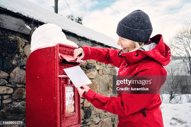 posting christmas cards from a village - openbare brievenbus stockfoto's en -beelden