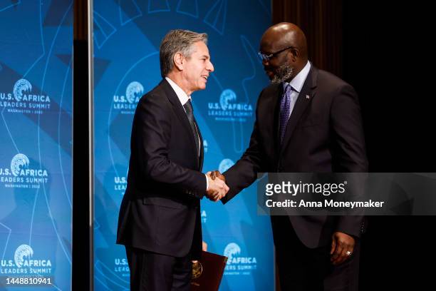Secretary of State Antony Blinken shakes hands with the President of Liberia George Weah at the opening plenary session for the African and Diaspora...
