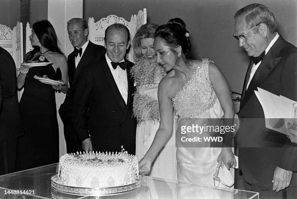 Jennifer Longoria , Bruno Pagliai , and Merle Oberon attend a party for the movie "Interval" in Mexico City on the weekend of March 3-4, 1973.