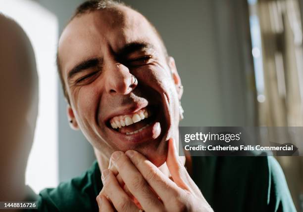 close-up of a man laughing - mundraum stock-fotos und bilder