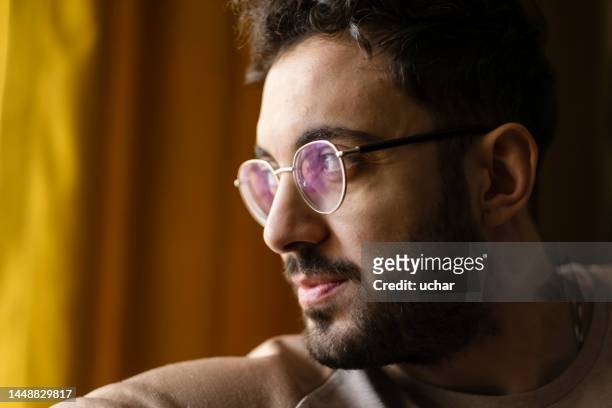 handsome glasses man looking out the window - soul searching stock pictures, royalty-free photos & images