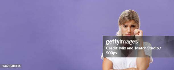 studio shot of offended sad and timid silly woman with blond hairstyle - studio shot lonely woman stock-fotos und bilder