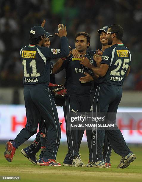 Deccan Chargers bowler Amit Mishra celebrates with teammates after taking the wicket of unseen Royal Challengers Bangalore batsman Mayank Agarwal...