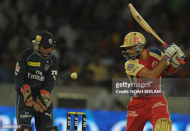 Royal Challengers Bangalore batsman Virat Kohli is watched by Deccan Chargers wicketkeeper Parthiv Patil as he plays a shot during the IPL Twenty20...