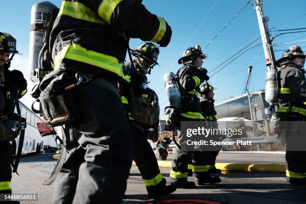 Firefighters and other emergency personnel work to control a large fire in the Brooklyn neighborhood of Red Hook on December 13, 2022 in New York...