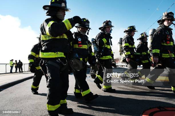 Firefighters and other emergency personnel work to control a large fire in the Brooklyn neighborhood of Red Hook on December 13, 2022 in New York...